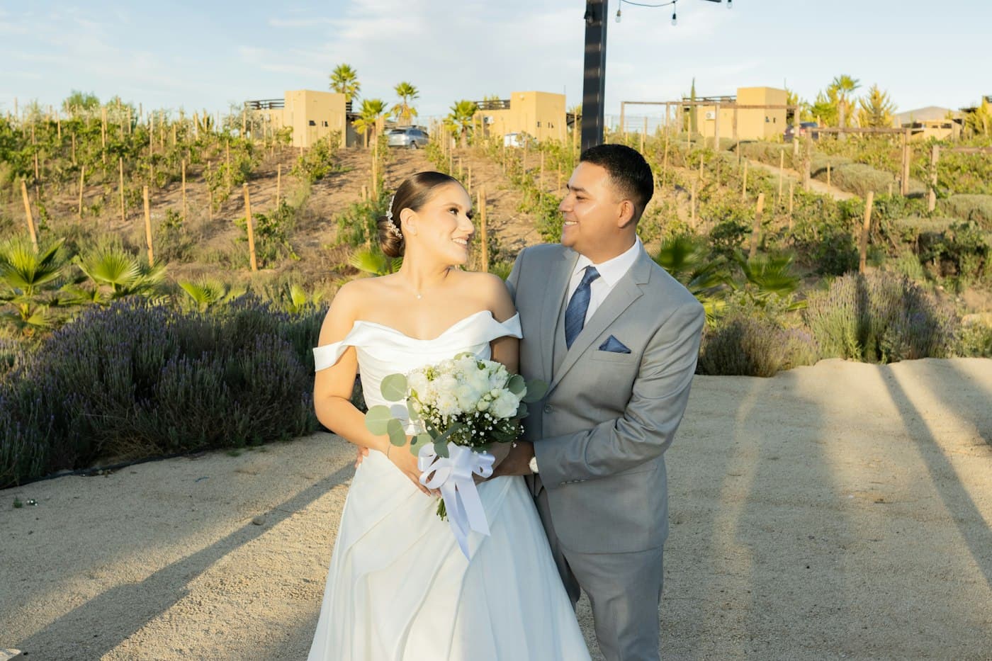 A bride's cape flying on a windy beach